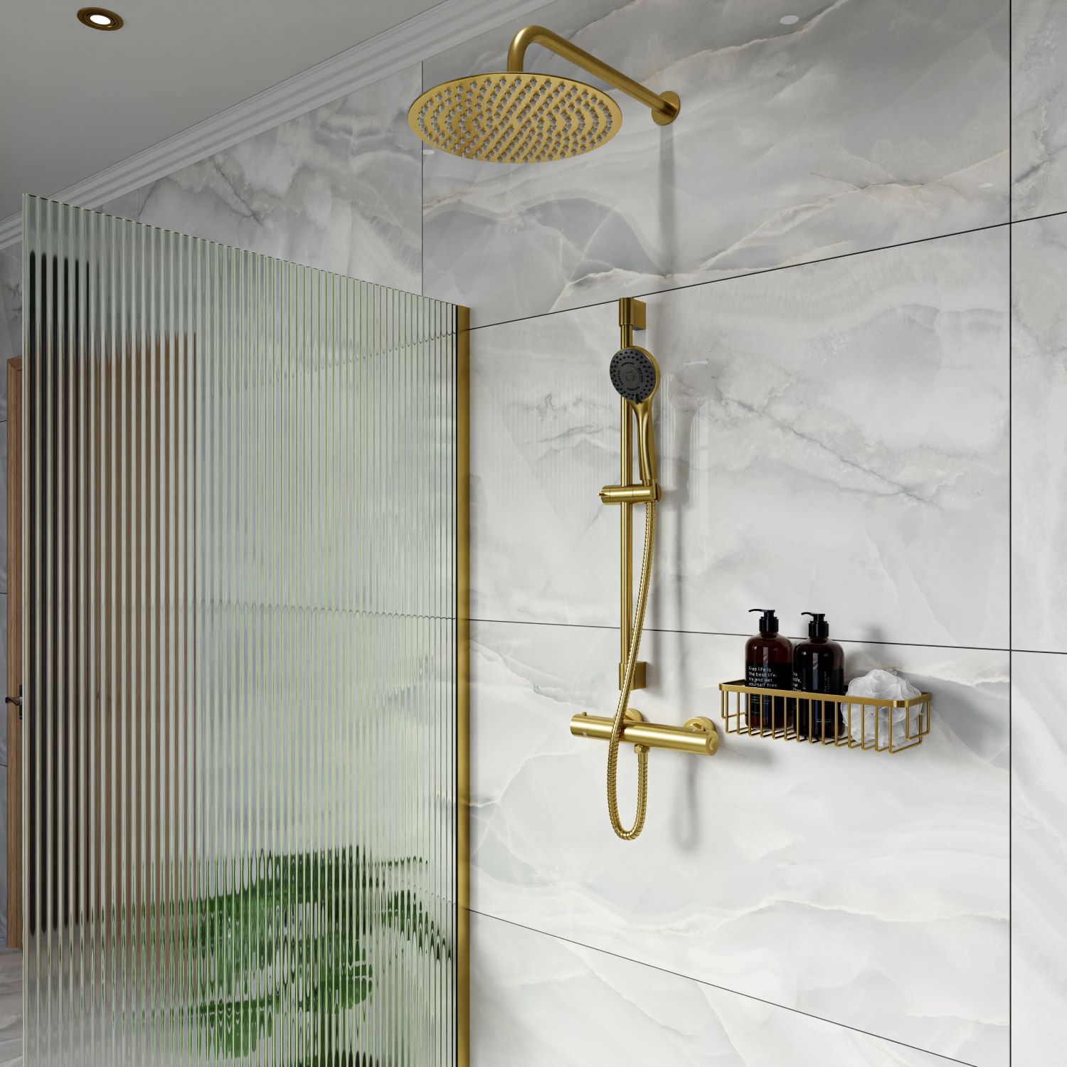 Brushed brass shower with fixed head and riser kit, against marble tiles with a fluted glass shower screen