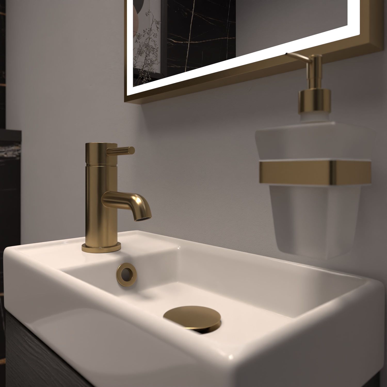 Close up of cloakroom basin with brushed brass tap, overflow and soap dispenser