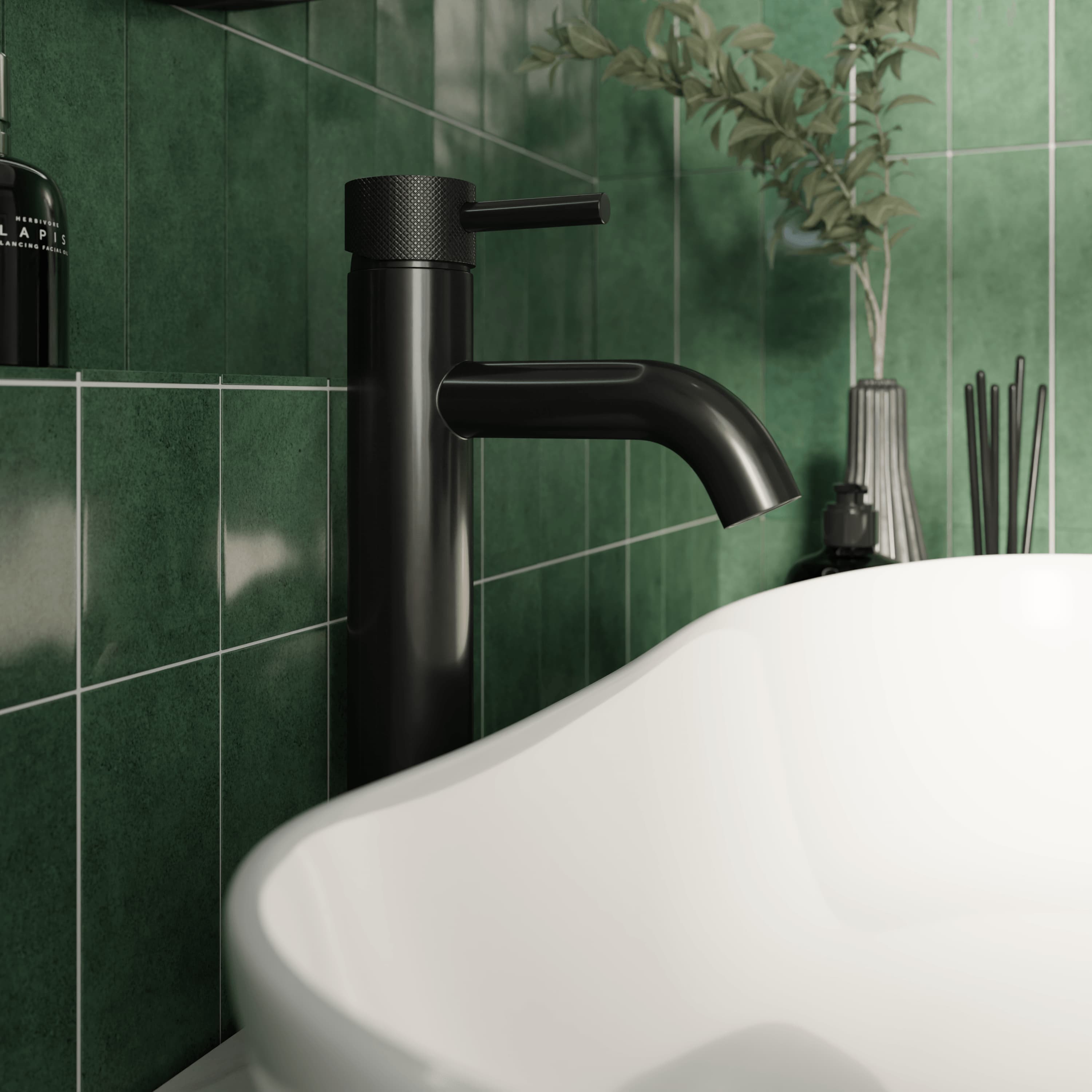 Matt black bathroom tap with green tiles