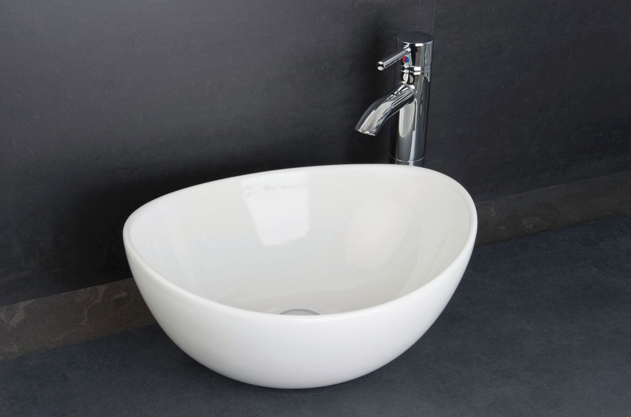 White counter top basin with deck mounted chrome tap