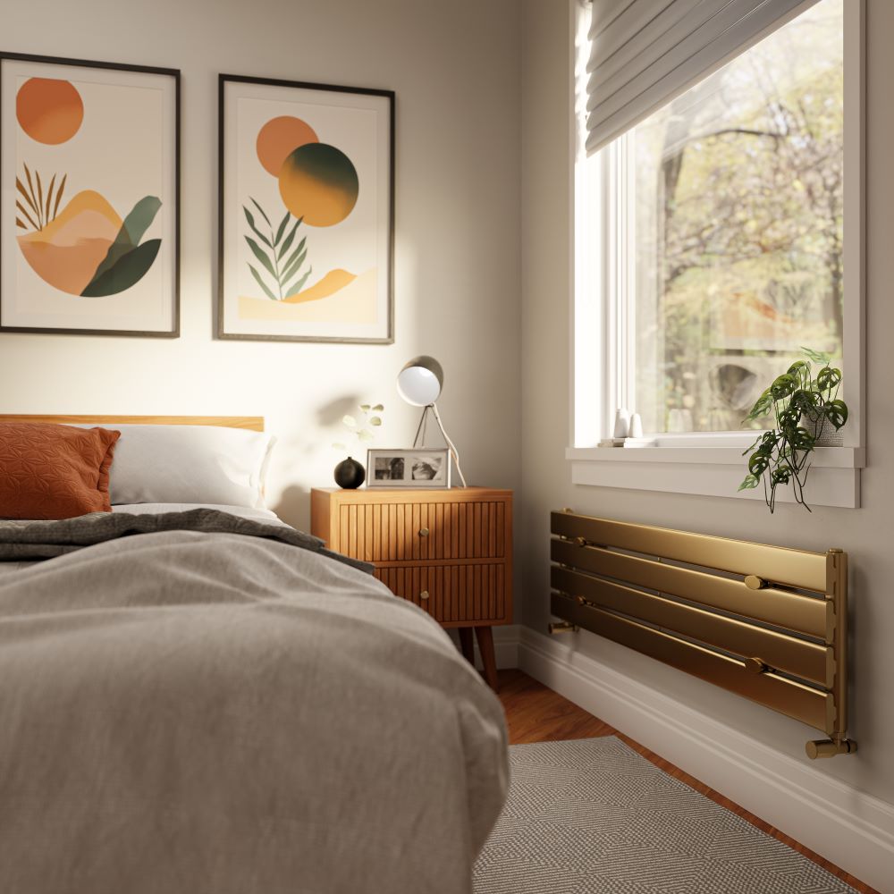 A modern brushed brass horizontal radiator