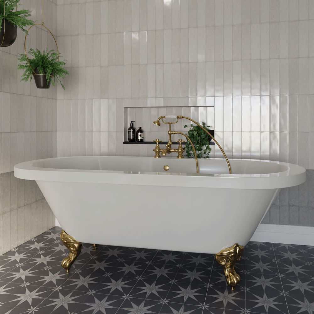 Freestanding bath with brass claw feet and brass tap and shower head