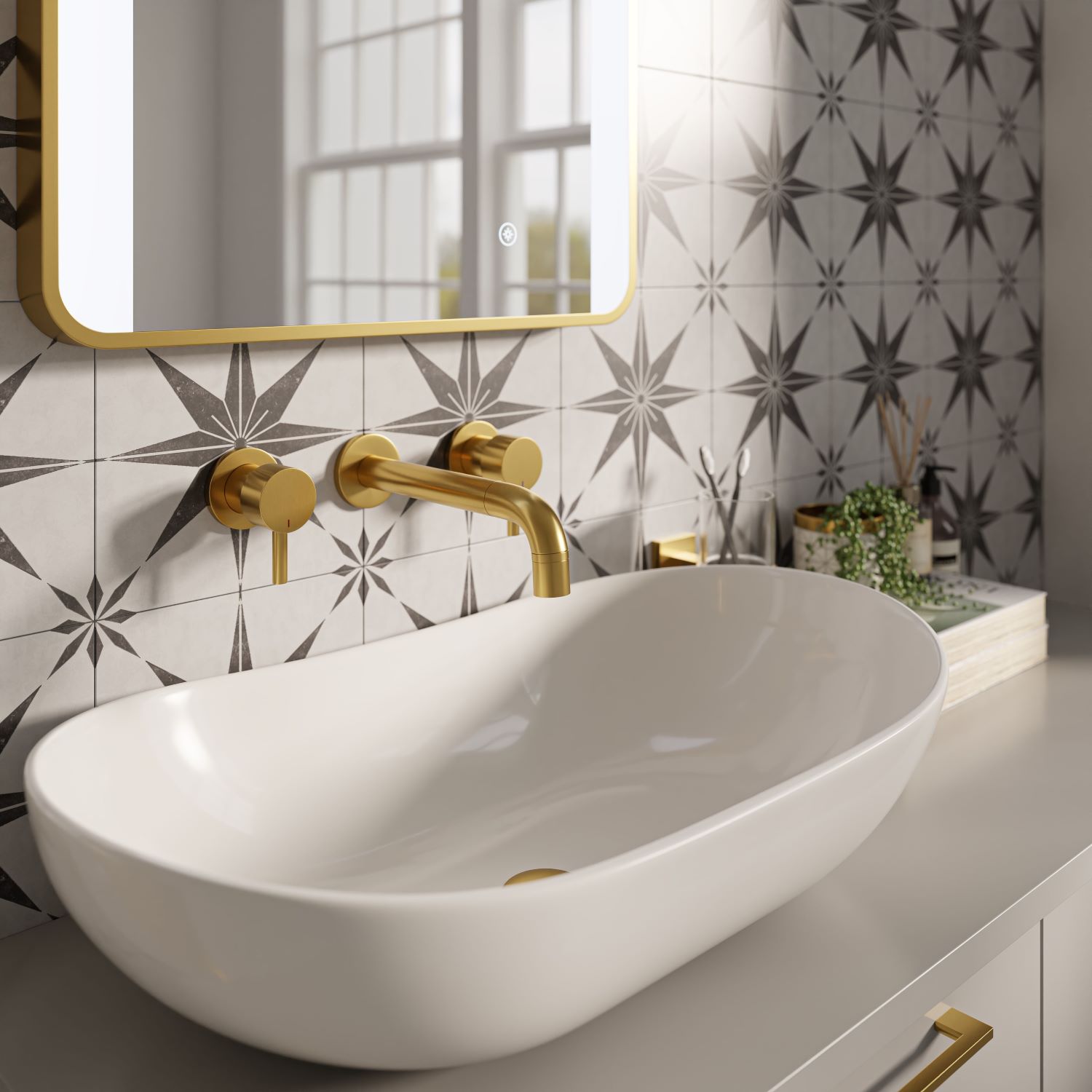 Close up of oval countertop basin with brushed brass wall mounted taps