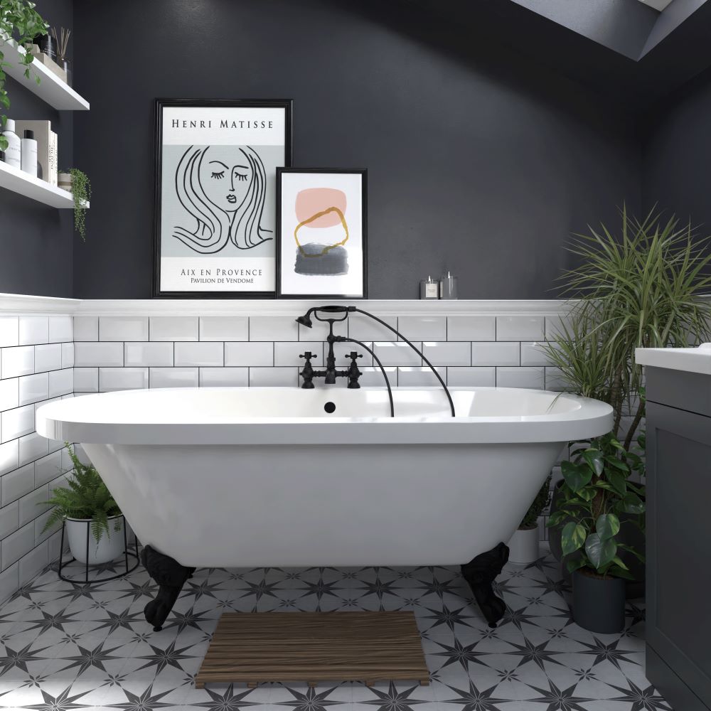 Freestanding bath with black claw feet and black taps